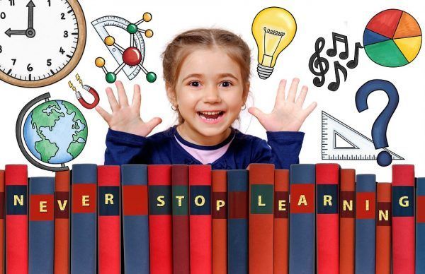 elementary girl with books doing homework